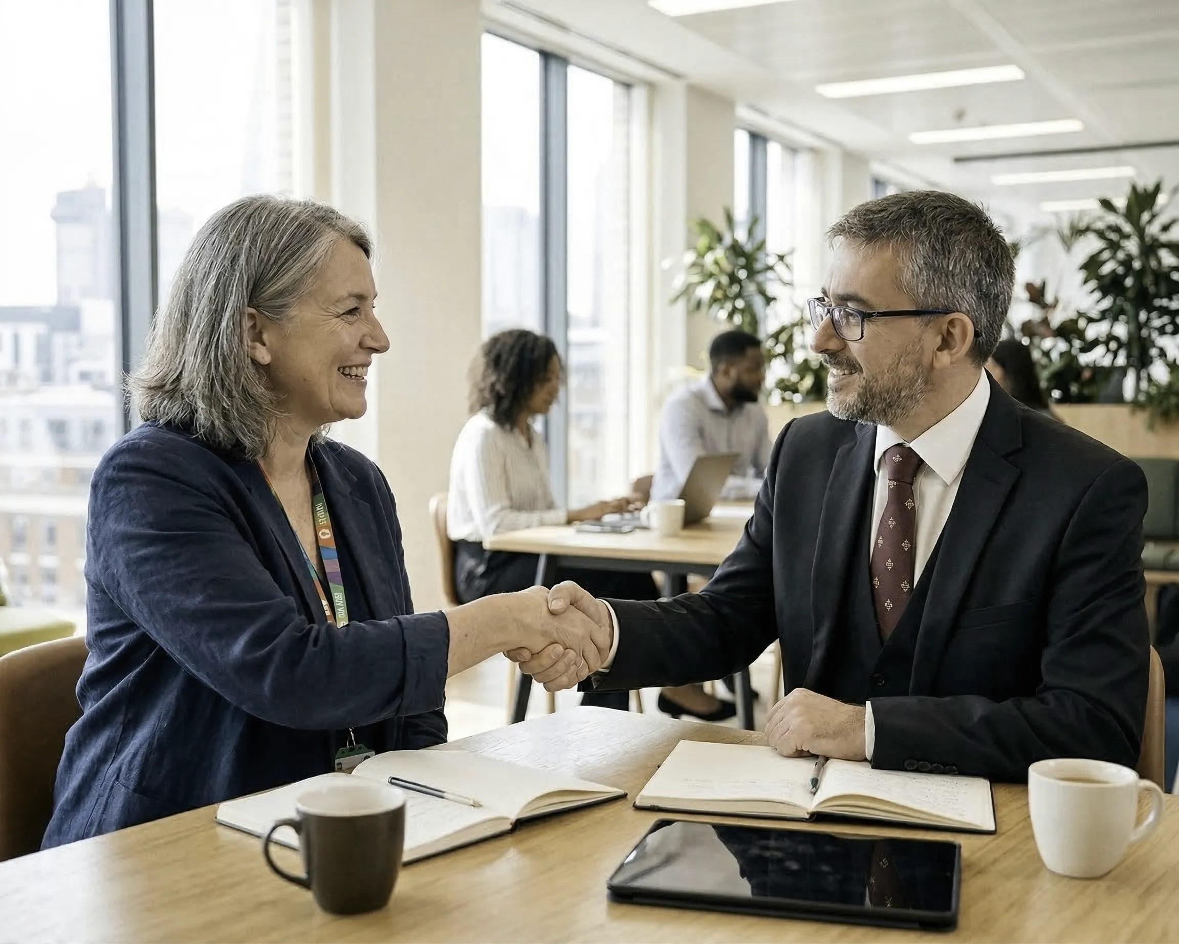 Partners shaking hands — representing the collaborative approach of social investment advisory